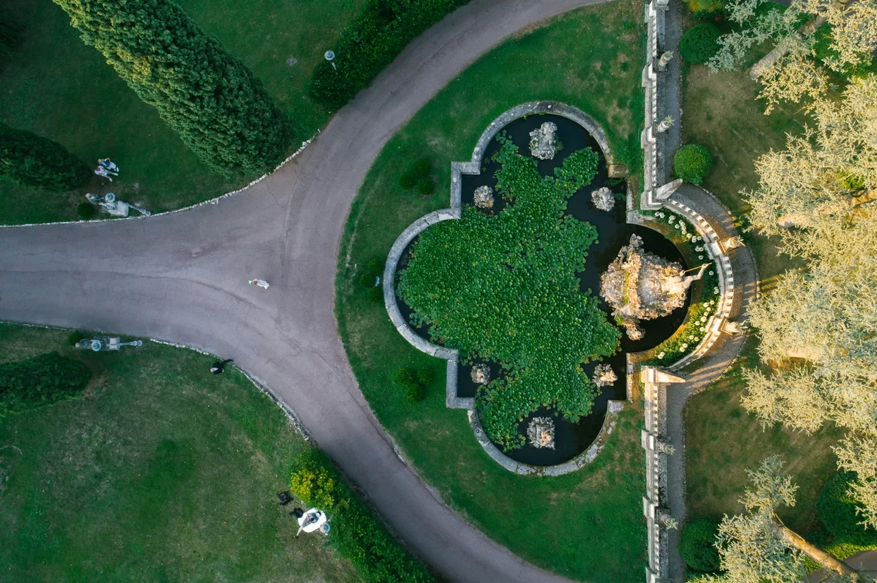 bird view on a park with a path forking in front of a fountain